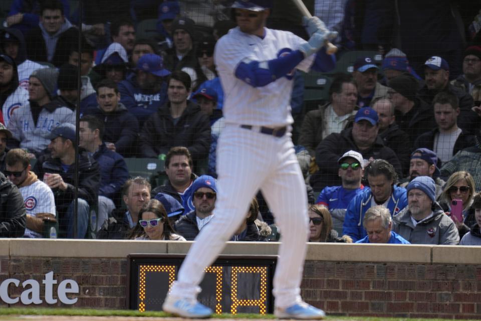 The pitching clock winds down behind Chicago Cubs batter Ian Happ during the first inning of a baseball game against the Milwaukee Brewers Thursday, March 30, 2023, in Chicago. (AP Photo/Erin Hooley)