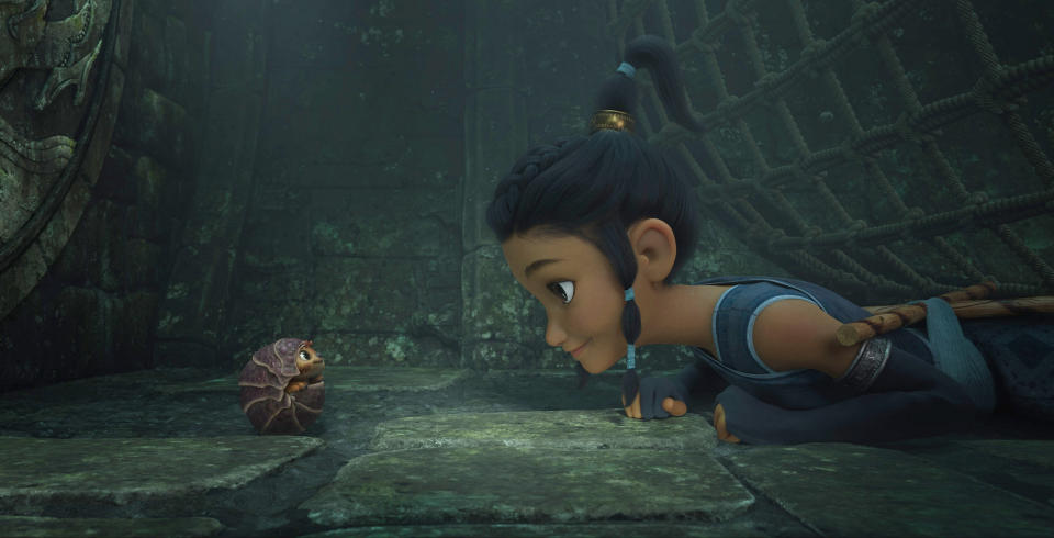 Animated character Raya, voiced by Kelly Marie Tran, right, appears with Tuk Tuk, voiced by Alan Tudyk, in a scene from "Raya and the Last Dragon." (Disney+ via AP)