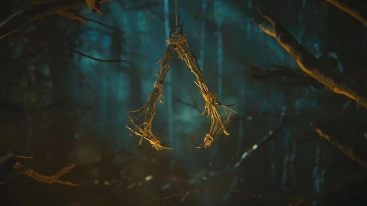  Assassins Creed Codename Hexe logo, formed from a bundle of twigs ganging from a branch. 