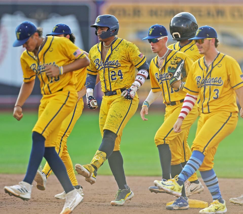 Bananas players dance at second base after Dakota McFadden's RBI during the Savannah Bananas' World Tour at Canal Park, Monday, July 3, 2023, in Akron, Ohio.