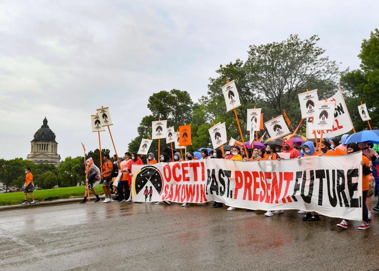 NDN Collective leads a demonstration past the South Dakota capitol building after the final draft of the state's proposed social studies standards left out multiple specific references to the Oceti Sakowin on Monday, September 13, 2021.