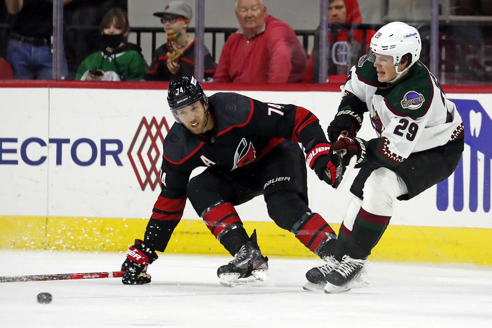 Carolina Hurricanes' Jaccob Slavin (74) tries to block the pass of Arizona Coyotes' Barrett Hayton (29) during the second period of an NHL hockey game in Raleigh, N.C., Sunday, Oct. 31, 2021. (AP Photo/Karl B DeBlaker)