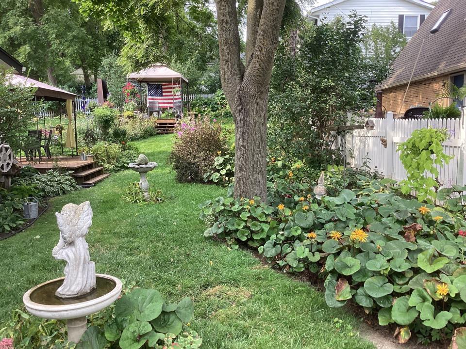The Gardens of West Bend Tour will feature this garden named Reminiscent Roots, with a cottage-style landscape of decks, whimsical garden art, and a playhouse for children.