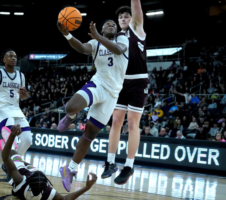 Classical Purple forward Jordan Duke goes up for a shot against La Salle defender Rex Zadrozny and over a fallen Timoy Stitchell in the second half.