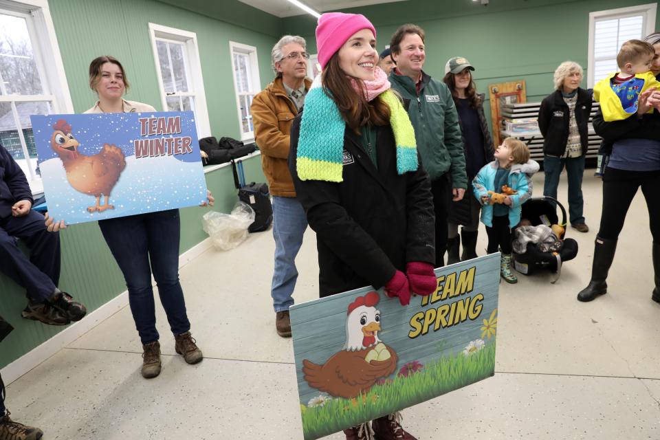Spectators held sign Team Winter and Team Spring signs while waiting to find out Cluxatawney Henrietta's prediction at Alfred B. DelBello Muscoot Farm in Katonah during a Groundhog Day celebration Feb. 2, 2024.
