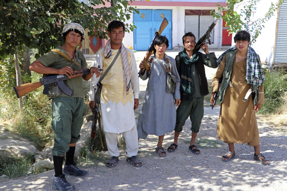 Militiamen loyal to Ata Mohammad Noor, chief of Jamiat-e-Islami, an Islamic political party, and a powerful northern warlord, pose for a photo while on patrol on the outskirts of Mazar-e-Sharif, northern Afghanistan, Tuesday, Aug. 10, 2021. (AP Photo/Mirwais Bezhan)