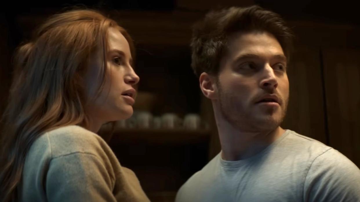  Madelaine Petsch as Maya and Froy Gutierrez as Ryan look toward a noise in a screenshot from the trailer of The Strangers: Chapter 1. 