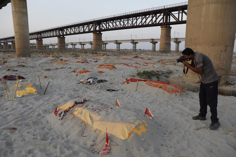 Bodies of suspected Covid-19 victims are seen in shallow graves buried in the sand near a cremation ground on the banks of Ganges River in Prayagraj, India, Saturday, May 15, 2021. (AP Photo/Rajesh Kumar Singh)