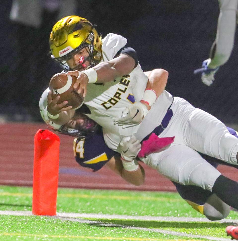 Copley quarterback DaOne Owens dives for a touchdown over Tallmadge's Keegan Gilbride on Oct. 14, 2022.