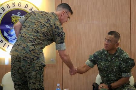 U.S. Marine Corps Brigadier General John Jansen (L) greets Commandant of Philippine Marine Corps, Maj. General Andre Costales Jr (C), during the opening ceremony of annual Philippines-US amphibious landing exercise (PHILBLEX) inside the Philippine Marines headquarters in Taguig city, metro Manila, Philippines October 4, 2016. REUTERS/Romeo Ranoco