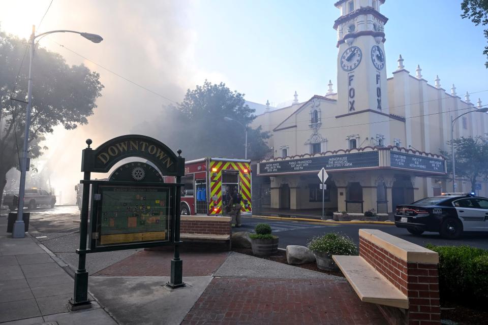 Heavy smoke fills Main Street on Sunday, May 1, 2022 as firefighters work a blaze in Downtown Visalia near the Fox Theatre.