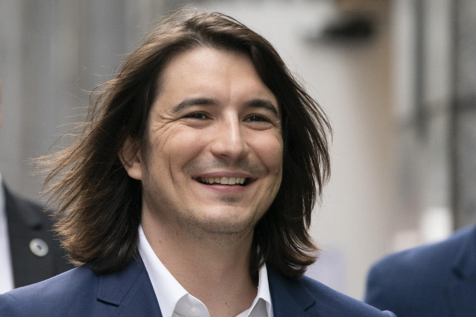 Vladimir Tenev, CEO and Co-Founder of Robinhood, walks in New York's Times Square following his company's IPO, Thursday, July 29, 2021. Robinhood is selling its own stock on Wall Street, the very place the online brokerage has rattled with its stated goal of democratizing finance. Through its app, Robinhood has introduced millions to investing and reshaped the brokerage industry, all while racking up a long list of controversies in less than eight years. (AP Photo/Mark Lennihan)