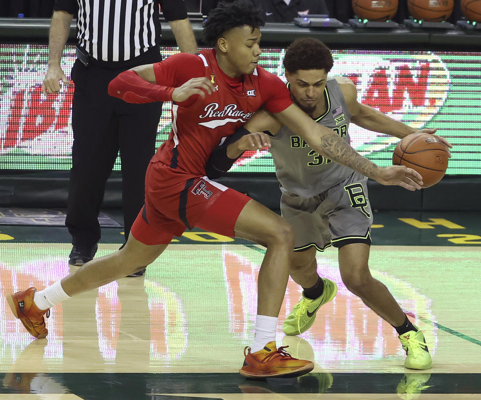 Baylor guard MaCio Teague (31) drives the ball against Texas Tech guard Terrence Shannon Jr. (1) in the second half of an NCAA college basketball game Sunday, March 7, 2021, in Waco, Texas. (AP Photo/Jerry Larson)