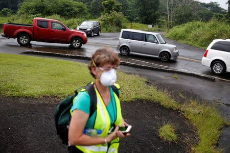 Drivers line up for free dust masks in Keaau to protect themselves from volcanic ash during ongoing eruptions of the Kilauea Volcano in Hawaii, U.S., May 17, 2018. REUTERS/Terray Sylvester