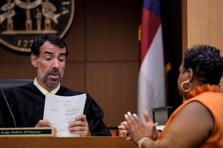 County Clerk Che Alexander, right speaks with Fulton County Superior Court Judge Robert McBurney, Monday, Aug. 14, 2023, in Atlanta. (AP Photo/Brynn Anderson)