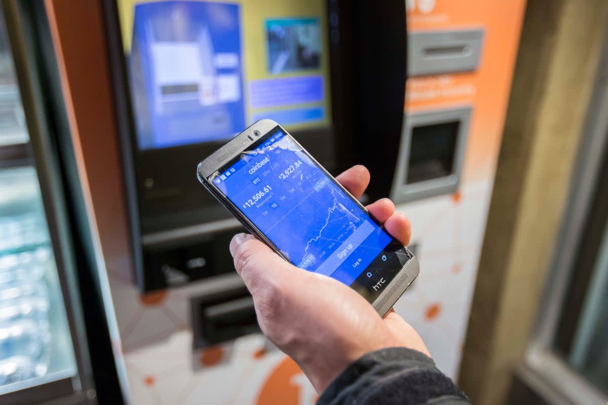 A customer uses a Bitcoin machine in Old Street underground station in London (Rick Findler/PA) (PA Archive)