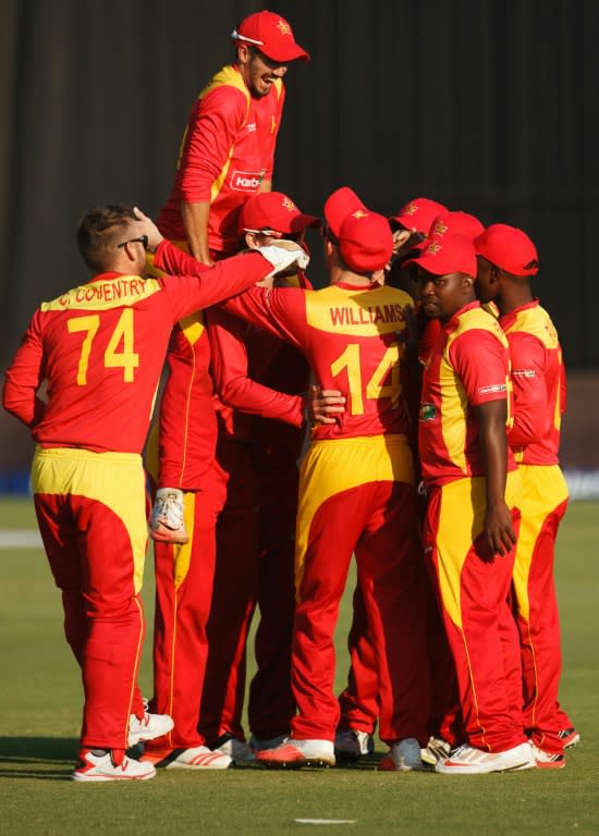 Zimbabwe players celebrate a wicket during the second and final game in a series of two Twenty20 international matches Zimbabwe and India on July 19, 2015 in Harare