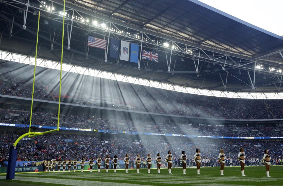 Cheerleaders line up before an NFL football game between Tennessee Titans and Los Angeles Chargers at Wembley stadium in London, Sunday, Oct. 21, 2018. (AP Photo/Matt Dunham)