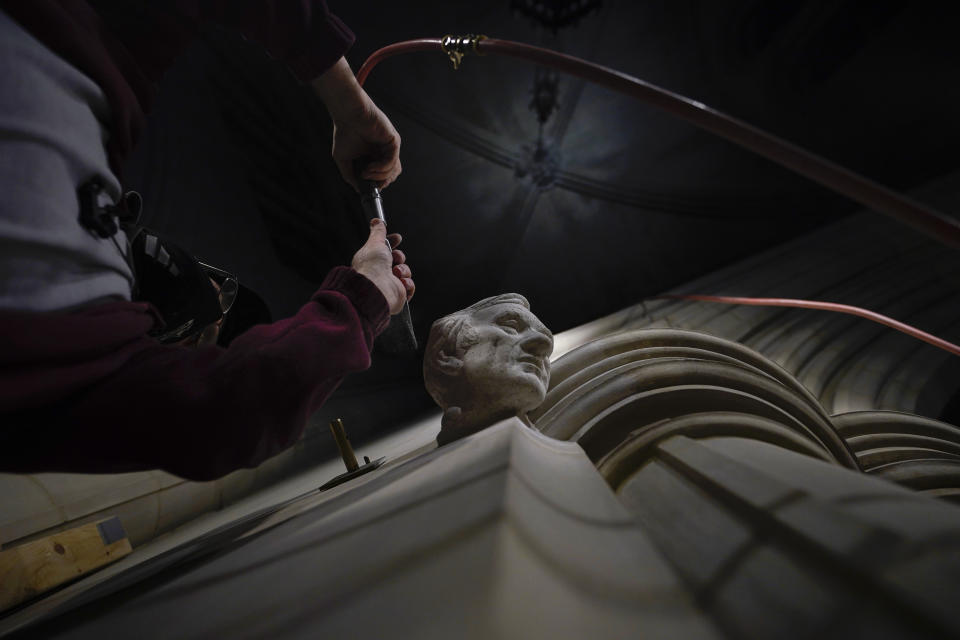 Washington National Cathedral stone carver Sean Callahan uses an air chisel to work on a sculpture of Holocaust survivor and Nobel Peace Prize winning author Elie Wiesel at the cathedral, Thursday, March 25, 2021. Wiesel, who died in 2016, became an outspoken advocate for human rights causes around the world, helped found the United States Holocaust Memorial Museum and was awarded the Nobel Peace Prize in 1986. (AP Photo/Carolyn Kaster)