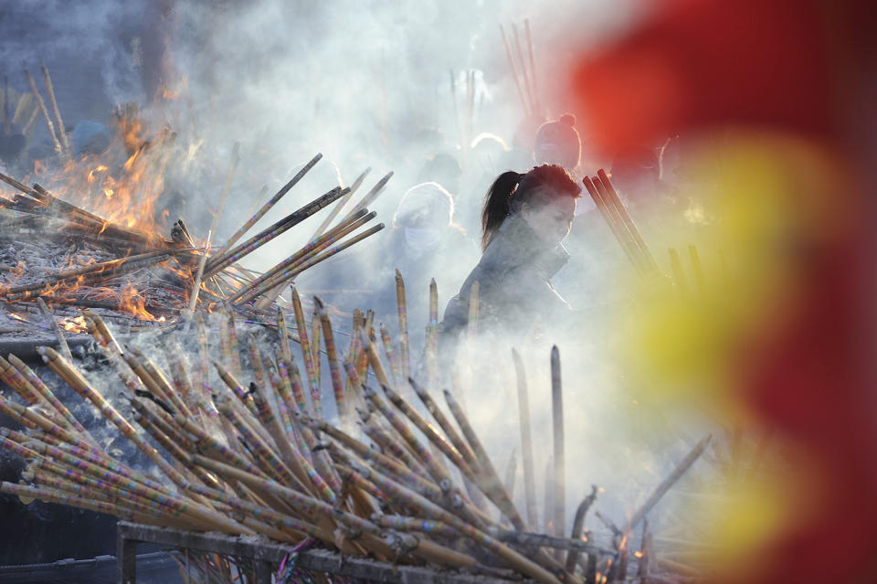 Chinese worshippers light incense as they pray at the Dacheng Temple on Jan 28, 2017 in Qiqihar, China. (Tao Zhang/NurPhoto via Getty Images)