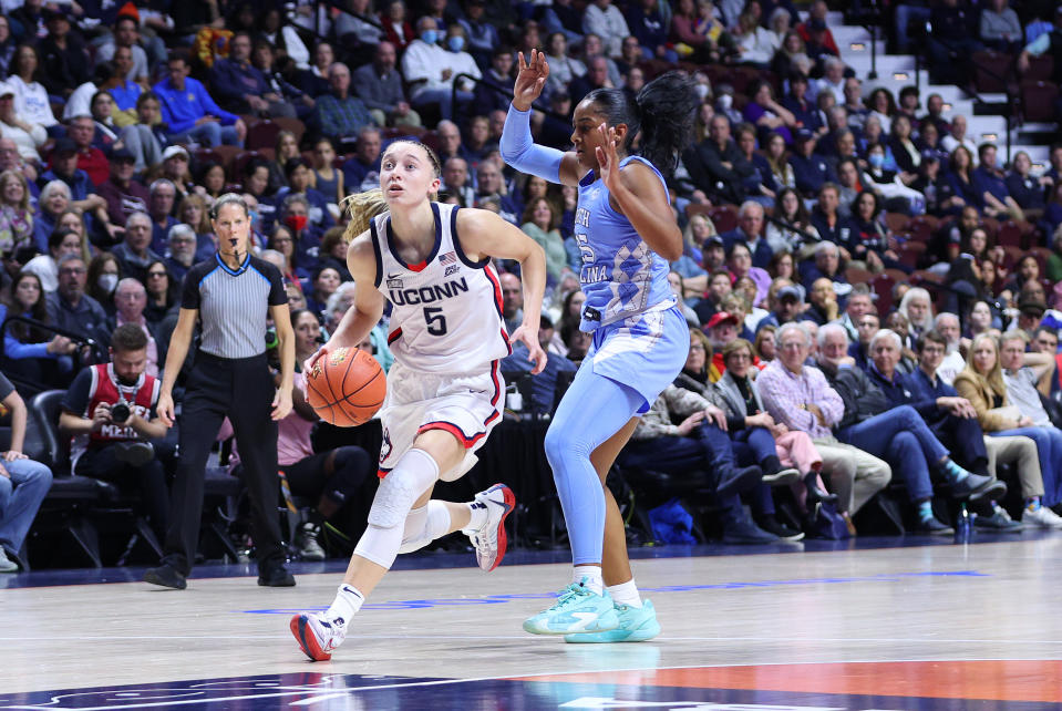 UConn guard Paige Bueckers drives to the basket against North Carolina guard Deja Kelly during the Basketball Hall of Fame Women's Showcase on Sunday. (Photo by M. Anthony Nesmith/Icon Sportswire via Getty Images)