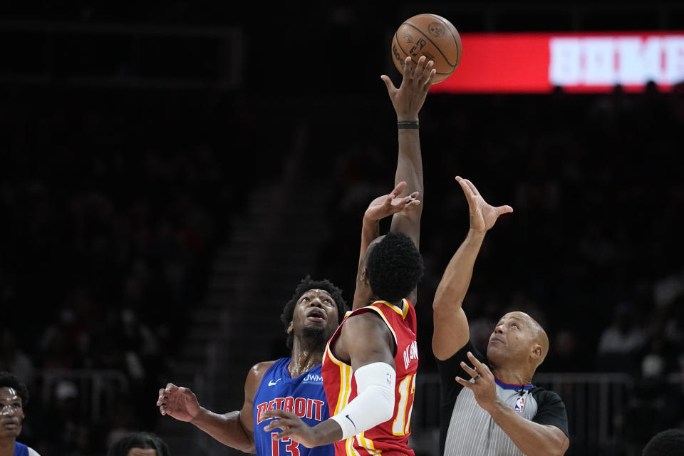 Detroit Pistons center James Wiseman (13) and Atlanta Hawks forward Onyeka Okongwu (17) reach for a jump ball during the first half of an NBA basketball game Monday, Dec. 18, 2023, in Atlanta. (AP Photo/John Bazemore)