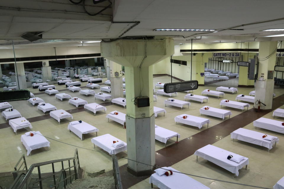 Housekeeping staff members prepare beds in a temporary quarantine facility for the incoming passengers inside a closed terminal building, at the Netaji Subhas Chandra Bose International Airport (CCU), after the government allowed domestic flight services to resume, during  the government extended nationwide lockdown to slow the spread of the coronavirus disease (COVID-19), in Kolkata, India, May  28,2020. (Photo by Debajyoti Chakraborty/NurPhoto via Getty Images)