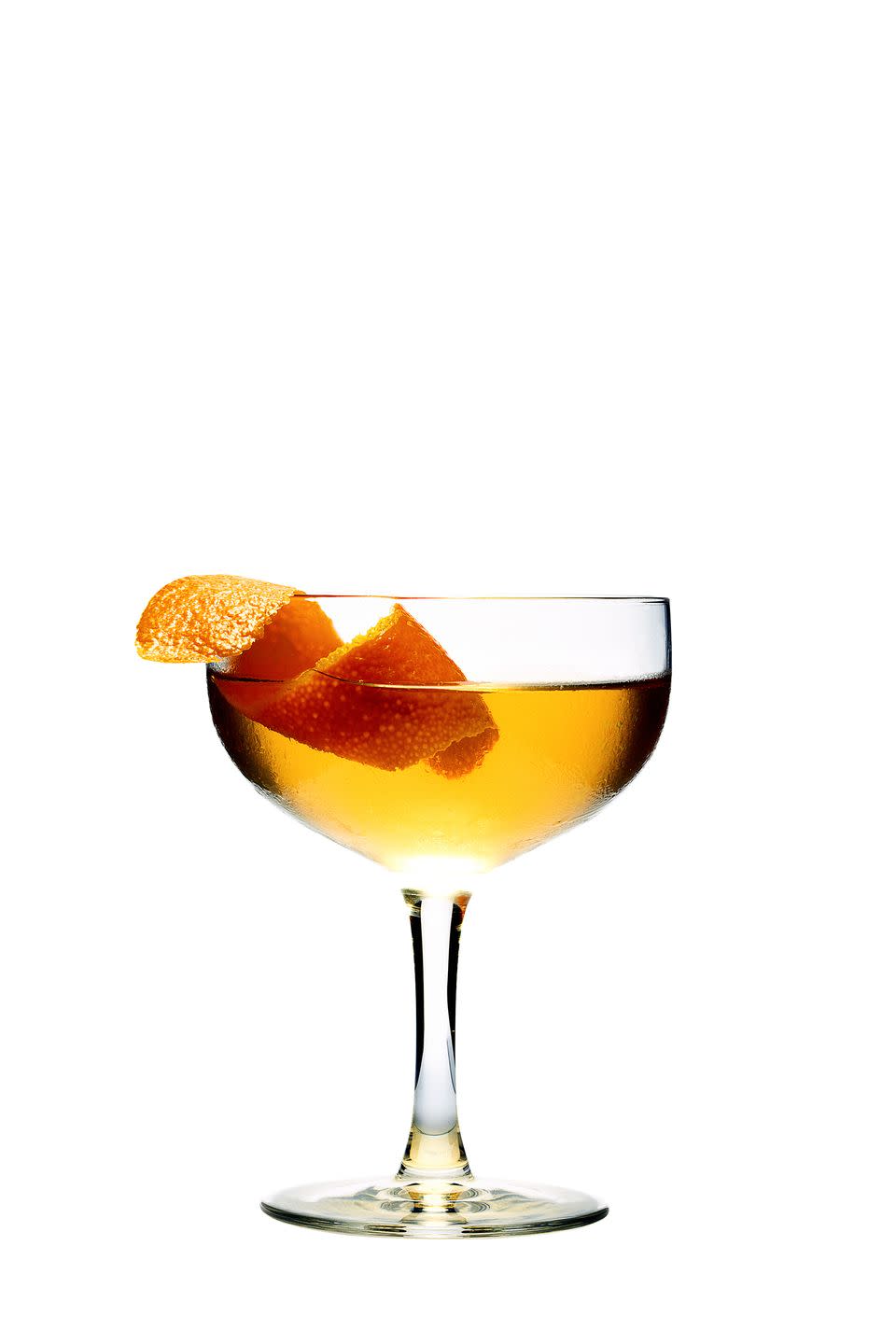 a glass of liquid with a slice of orange on top