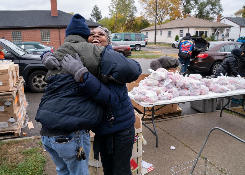 A volunteer hugs Janelle Coklow, 67, of Detroit, who was working at the church during Senior Day at First Baptist Institutional Church in Detroit on Wednesday, Oct. 19, 2022. Senior Day was created by the Rev. Dr. Robyn Moore, who partnered with Forgotten Harvest to distributes food to seniors with the help of volunteers.