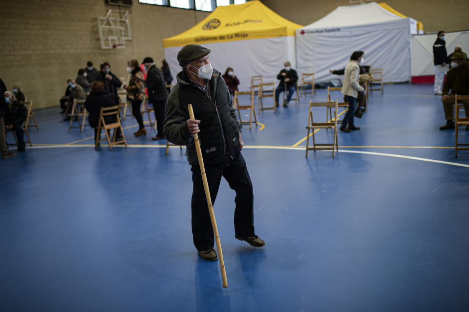 Emiliano Diaz, 81, leaves a sports center after receiving a Pfizer vaccine during a mass COVID-19 vaccination campaign in the small town of Santo Domingo de La Calzada, northern Spain, Wednesday, March 10, 2021. Regional governments have called for all residents over the age of 80 to be vaccinated. (AP Photo/Alvaro Barrientos)