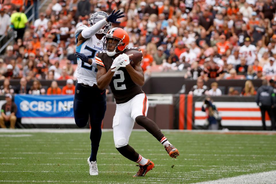 Cleveland Browns wide receiver Amari Cooper (2) catches a pass while being covered by Tennessee Titans cornerback Kristian Fulton (26) on Sunday in Cleveland.
