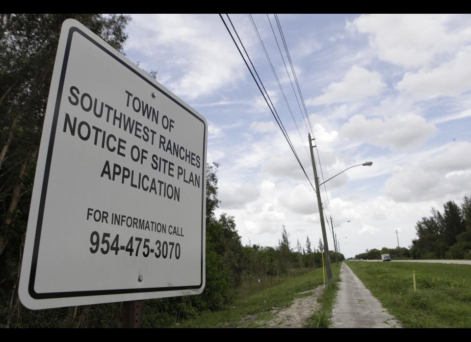 In this photo taken Tuesday, July 26, 2011, a sign is posted at the site for a proposed detention center to be built in Southwest Ranches, Fla. Town leaders in this upscale rural enclave have plans to build a 1,500-bed detention center facility for U.S. Immigration and Customs Enforcement. A growing group of residents from Southwest Ranches and neighboring cities are seeking to halt the effort. (AP Photo/Lynne Sladky)