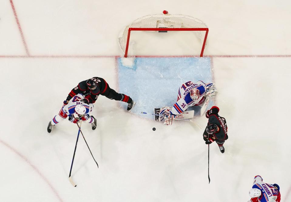 May 9, 2024; Raleigh, North Carolina, USA; New York Rangers goaltender Igor Shesterkin (31) and defenseman Adam Fox (23) watch the shot against Carolina Hurricanes center Sebastian Aho (20) and right wing Andrei Svechnikov (37) during the second period in game three of the second round of the 2024 Stanley Cup Playoffs at PNC Arena. Mandatory Credit: James Guillory-USA TODAY Sports