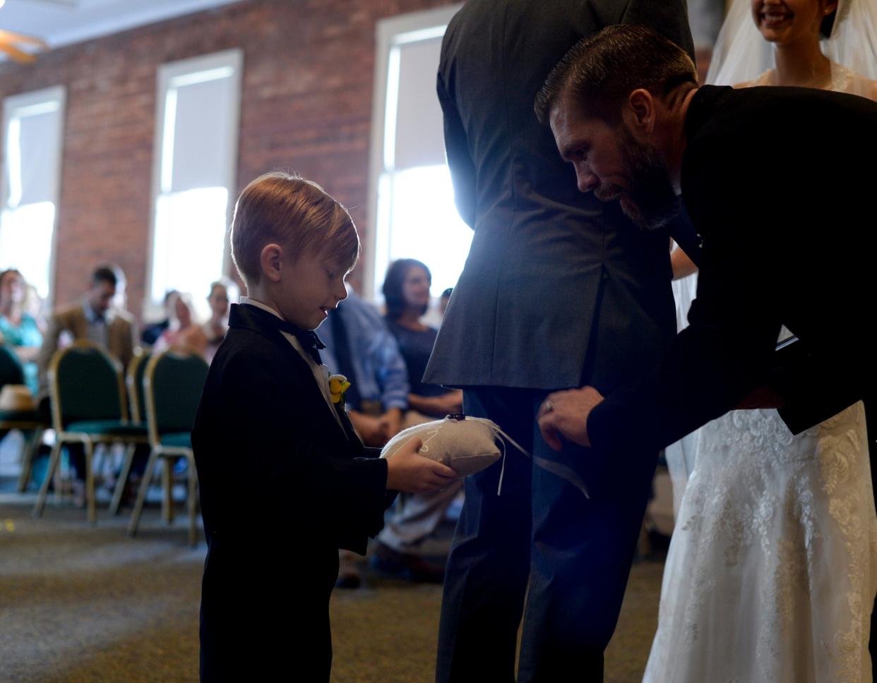 The ring bearer presents the rings to the Pastor at a wedding in Waycross, Georgia, July 2, 2017. The marriage between two military members was witnessed by friends and family. (U.S. Air Force photo by Airman 1st Class Kristen Heller)