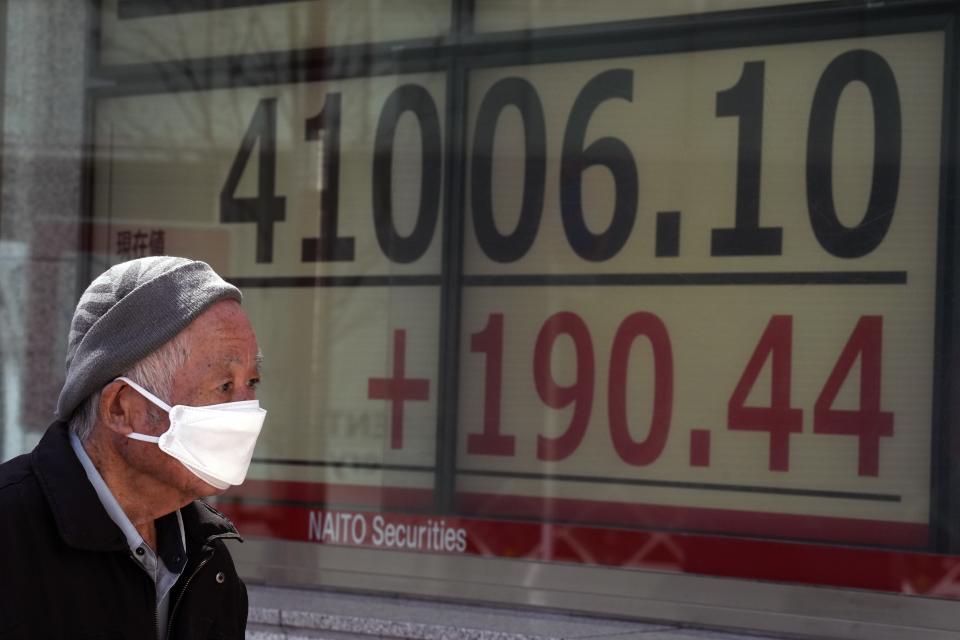 A person looks at an electronic stock board showing Japan's Nikkei 225 index at a securities firm Friday, March 22, 2024, in Tokyo. Stocks were mostly lower Friday in Asia after Wall Street tapped fresh records, led by big gains in chipmakers.(AP Photo/Eugene Hoshiko)