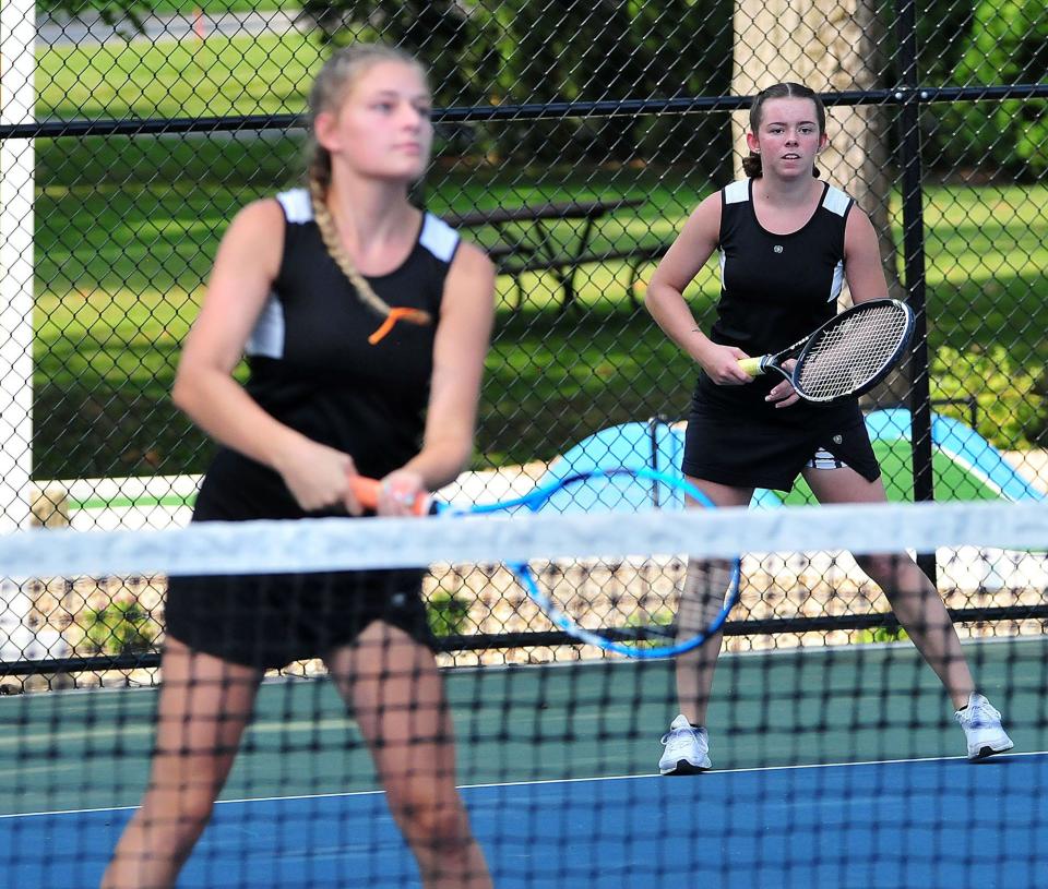 Ashland High School’s Haley Lefever, right, eyes the ball alongside doubles partner Chloe Ediger in first doubles during an Ashland Invitational hosted by the Ashland High School girls tennis team at Brookside Park Saturday, Aug. 7, 2021. LIZ A. HOSFELD/FOR TIMES-GAZETTE.COM