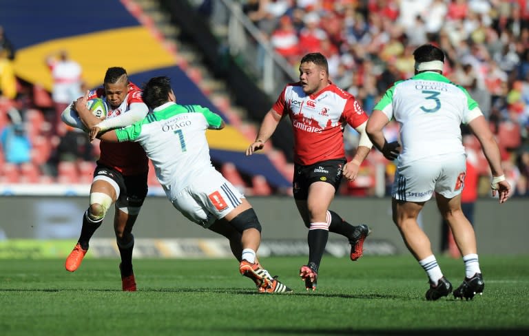 Lions' Elton Jantjies is tackled by Highlanders' Daniel Lienert-Brown during the SuperXV rugby semi-final match between Lions and Highlanders at Ellis Park on July 30, 2016