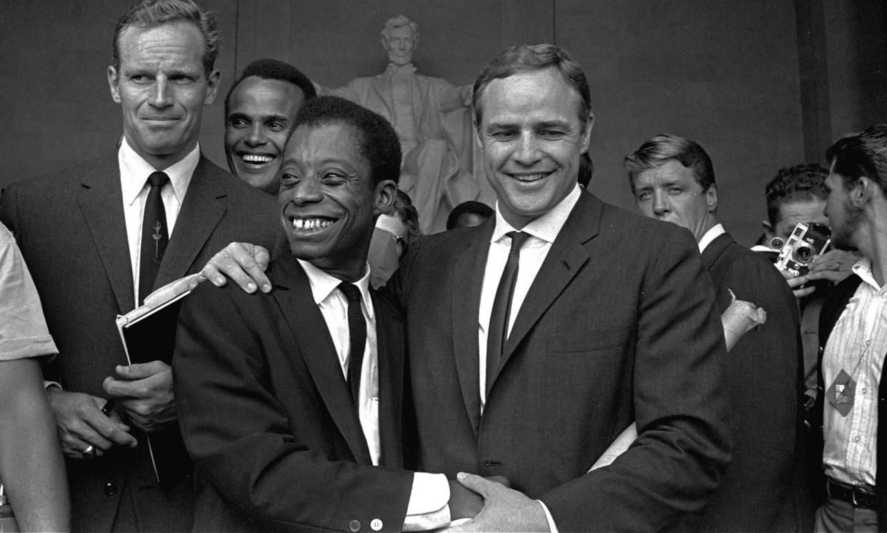 <span>‘Baldwin discovered the cinema before he discovered books’ … the writer with Marlon Brando (centre) at the Lincoln Memorial in 1963, with Charlton Heston (left) and Harry Belafonte (behind).</span><span>Photograph: AP</span>