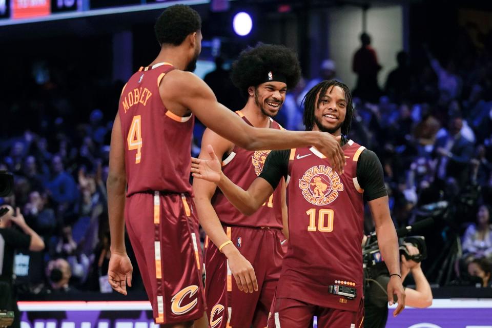 Darius Garland (10) celebrates with Cavaliers teammates Evan Mobley (4) and Jarrett Allen after winning the team shooting part during the Skills Challenge, part of NBA All-Star Weekend, Saturday, Feb. 19, 2022, in Cleveland.  The Cavs trio won the overall Skills Challenge.