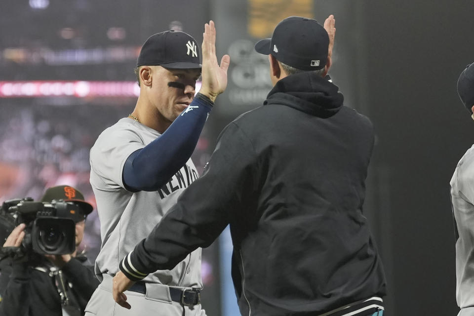 New York Yankees' Aaron Judge, left, celebrates with a teammate after the Yankees defeated the San Francisco Giants in a baseball game in San Francisco, Friday, May 31, 2024. (AP Photo/Jeff Chiu)