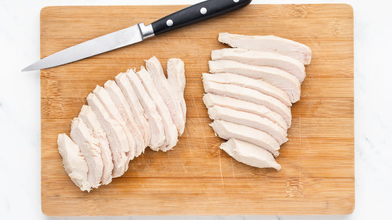 Sliced chicken on cutting board