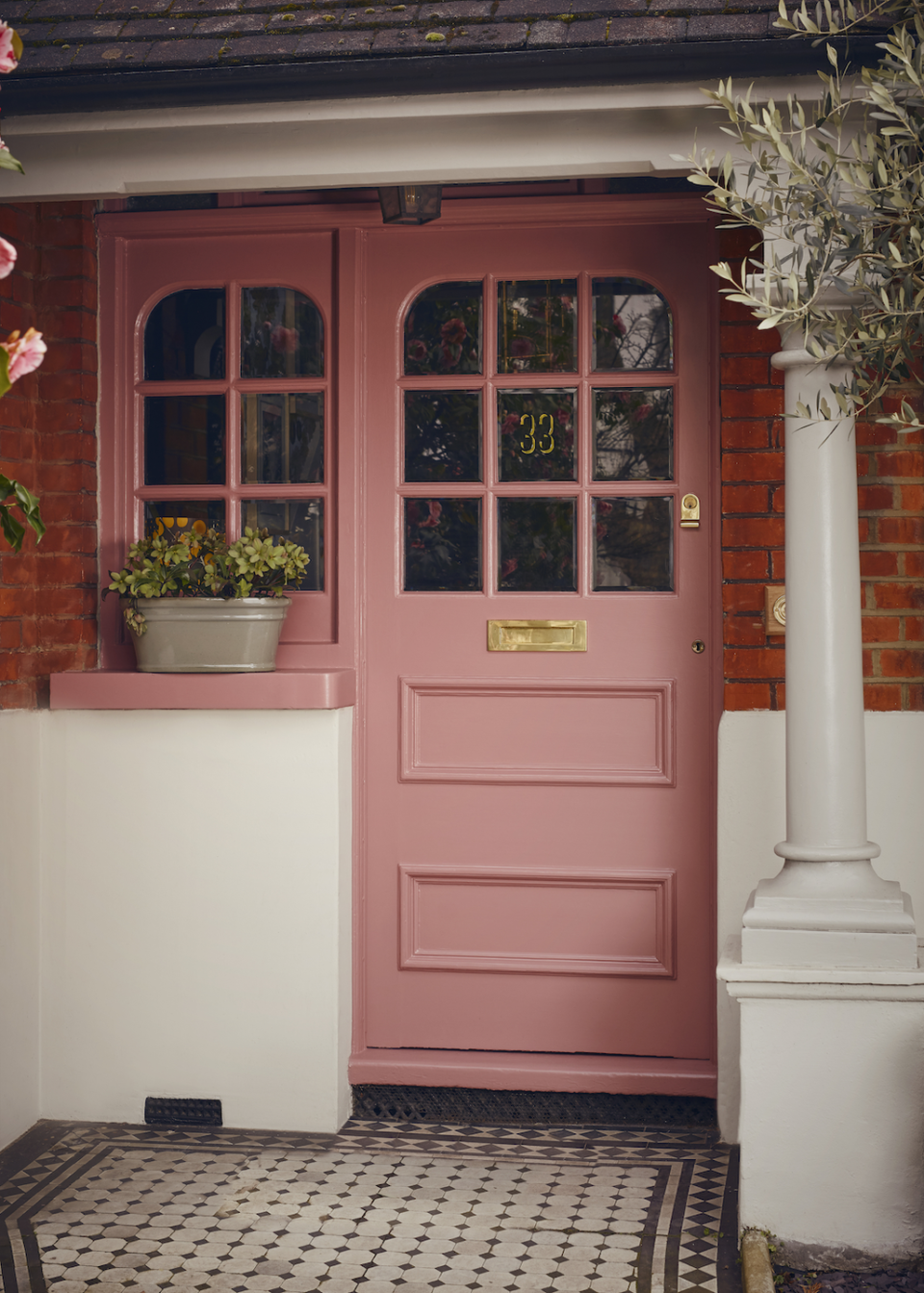 a pink door with a white pillar