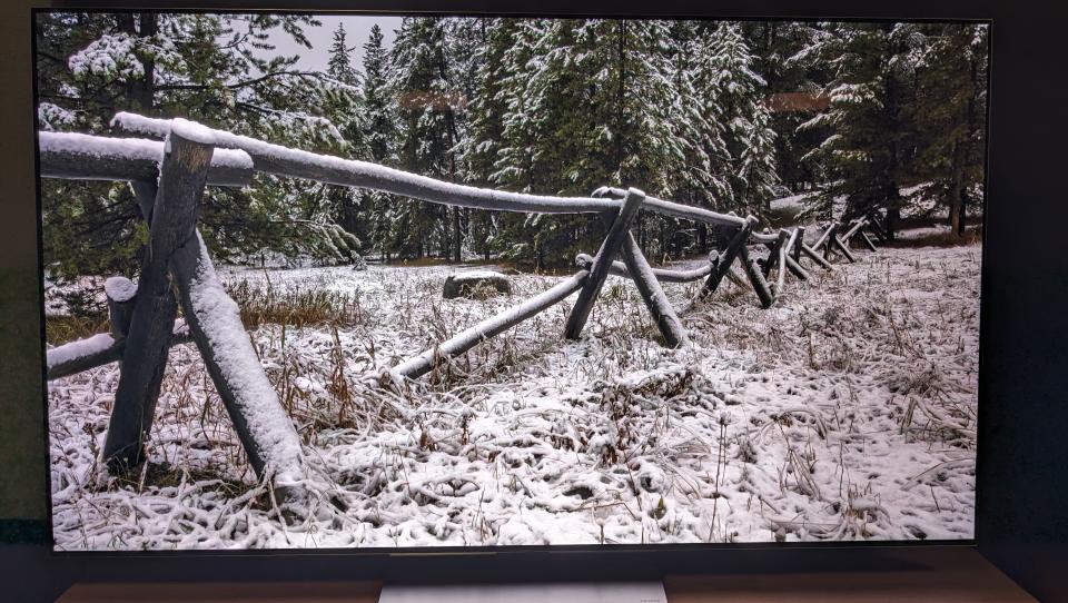 LG G3 with snowy scene and wooden fence on screen