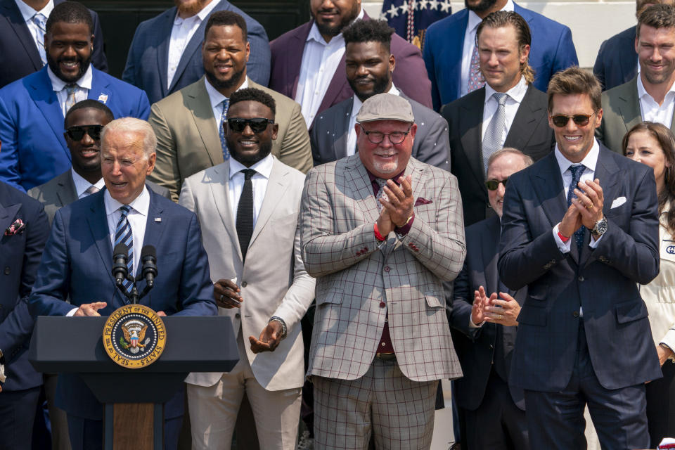President Joe Biden, surrounded by members of the Tampa Bay Buccaneers, including Tampa Bay Buccaneers head coach Bruce Arians, second from right, and Tampa Bay Buccaneers quarterback Tom Brady, right, speaks during a ceremony on the South Lawn of the White House in Washington, Tuesday, July 20, 2021, where the president honored the Super Bowl Champion Tampa Bay Buccaneers for their Super Bowl LV victory. (AP Photo/Andrew Harnik)