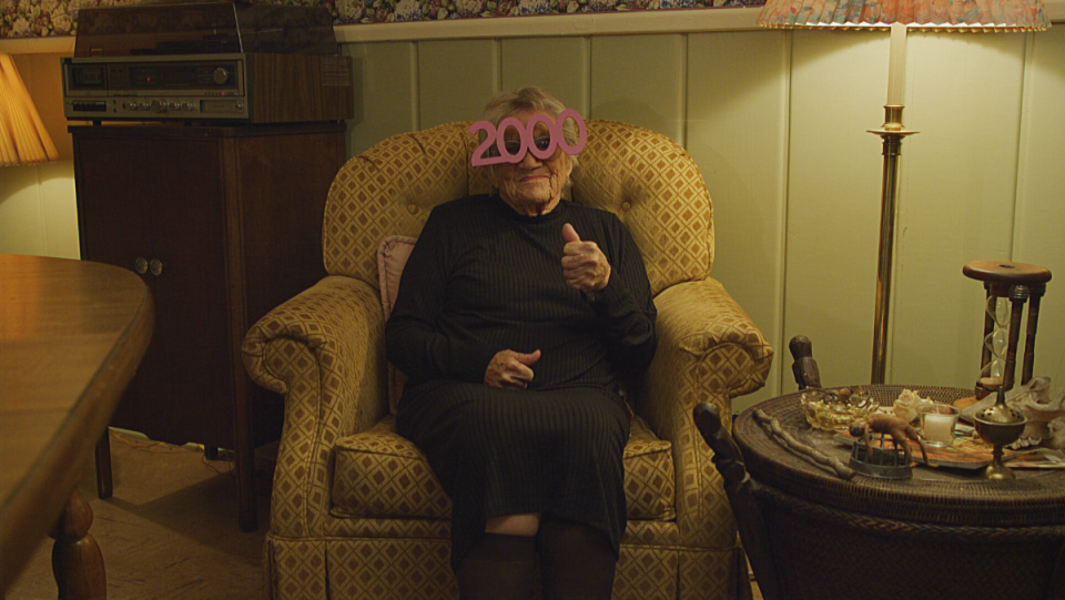 v/h/s/99 anthology first look photo of older woman wearing year 2000 glasses 