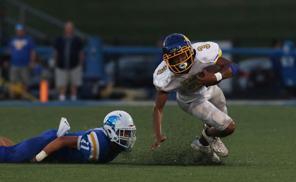 Maysville's Nate Harper trips up West Muskingum's Rashid Sesay during a 31-7 loss during the 2021 season in Newton Township. Sesay will move to quarterback this season to replace graduated Harley Hopkins.