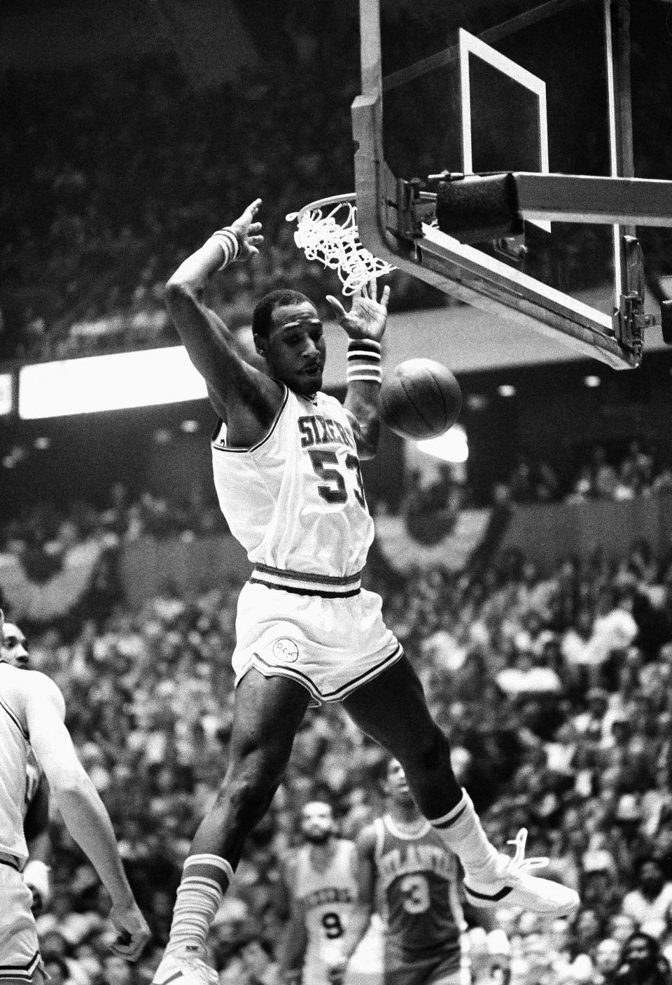 FILE - Philadelphia 76ers' Darryl Dawkins dunks against the Atlanta Hawks in an NBA playoff game in Philadelphia, on April 15, 1980. Bill Willoughby helped pave the way for future prep stars when he and Dawkins became the first high school players selected in the NBA draft, both in 1975. (AP Photo/Rusty Kennedy, File)