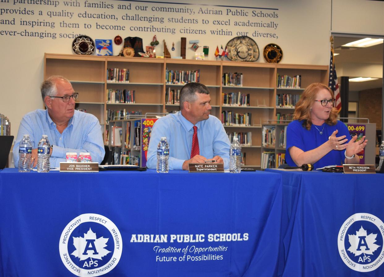 Adrian Public Schools Superintendent Nate Parker, center, received the results of his annual evaluation during the Adrian Board of Education's meeting Monday. The board rated Parker "effective." Also pictured are board Vice President Jon Bacuher, left, and President Beth Ferguson, right.