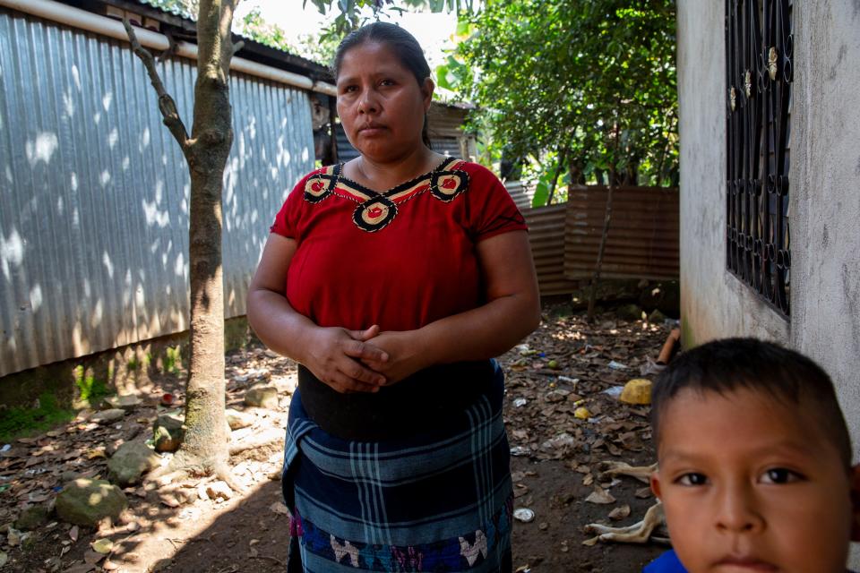 María Guarchaj stands outside of her home with her youngest son, Juan Carlos. Guarchaj traveled alone to Guatemala City to receive the repatriated body of her son. While waiting for his remains she learned that Diego Suy Guarchaj was in fact alive.