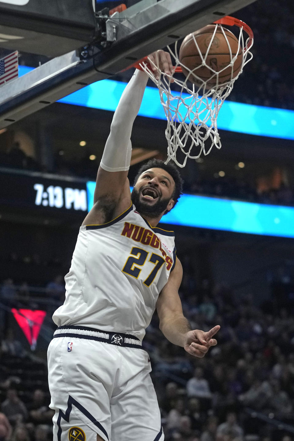 Denver Nuggets guard Jamal Murray (27) dunks against the Utah Jazz during in the first half of an NBA basketball game Tuesday, April 9, 2024, in Salt Lake City. . (AP Photo/Rick Bowmer)